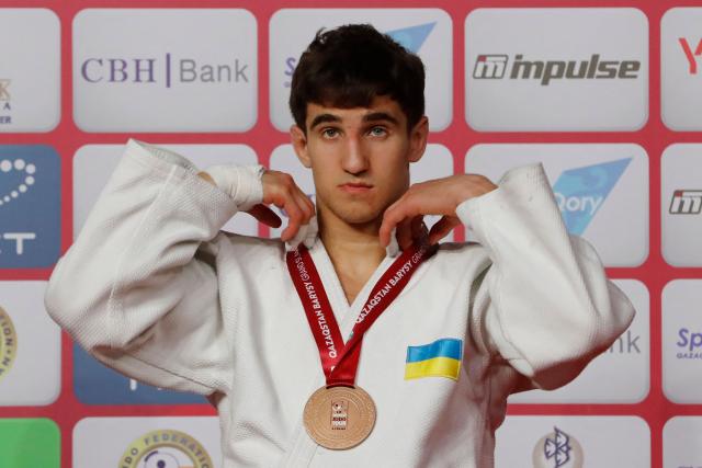 Bronze medallist Ukraine's Vladyslav Kolobov celebrates during the medal ceremony for the men's under 81 kg event at the Astana Grand Slam judo tournament in Astana on May 9, 2026. (Photo by STANISLAV FILIPPOV / AFP)