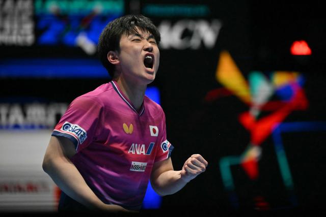 Japan's Tomokazu Harimoto reacts while playing against Taiwan's Lin Yun-ju during their Men's Teams semi-final match at the ITTF World Table Tennis Championships in Wembley Arena, west London on May 9, 2026. (Photo by Glyn KIRK / AFP)