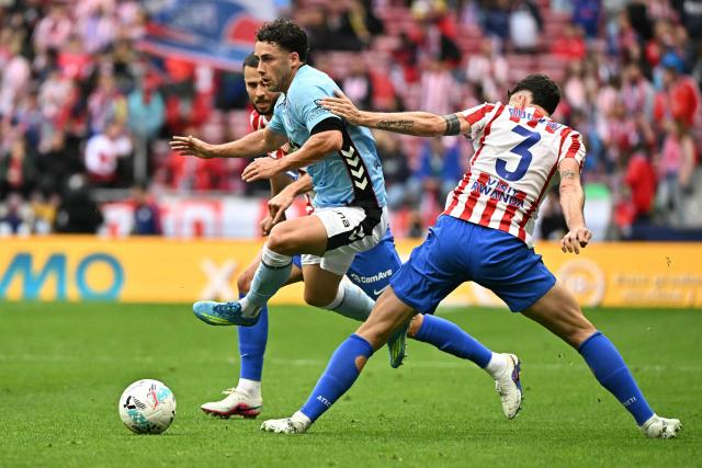 Celta Vigo's Spanish forward #18 Pablo Duran (L) runs with the ball past Atletico Madrid's Italian defender #03 Matteo Ruggeri during the Spanish league football match between Club Atletico de Madrid and RC Celta de Vigo at the Metropolitano Stadium in Madrid on May 9, 2026. (Photo by Javier SORIANO / AFP)