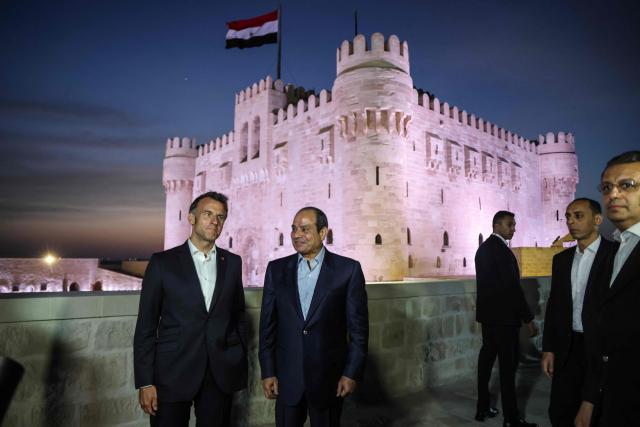 France's President Emmanuel Macron (L) and his Egyptian counterpart Abdel Fattah al-Sisi (C) visit the Citadel of Qaitbay in Alexandria on May 9, 2026. Macron on May 9 embarked on a visit to Africa aimed at renewing France's engagement with the continent after years of strained ties with former French speaking colonies, also travelling to Egypt, Ethiopia and Kenya. (Photo by Ludovic MARIN / AFP)