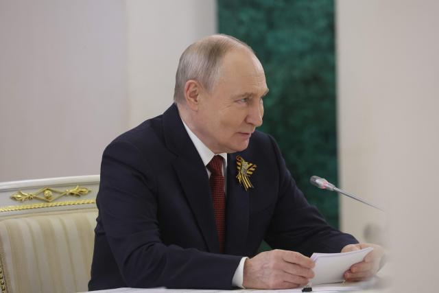 Russian President Vladimir Putin attends a meeting with President of Republika Srpska and Bosnian Serb leader at the Kremlin in Moscow on May 9, 2026. (Photo by MAXIM SHIPENKOV / POOL / AFP)