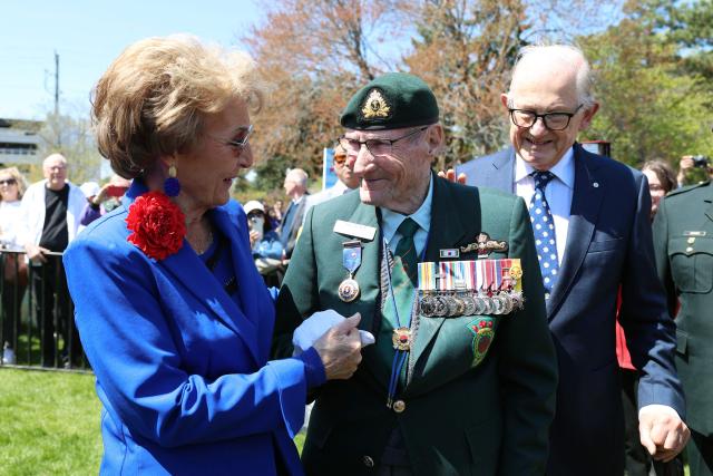 Princess Margriet of the Netherlands and her husband Pieter van Vollenhoven (R), greet Canadian Korean War veteran Bill Black (C) at The Canadian Tulip Festival May 9, 2026 in Ottawa, Canada. Princess Margriet, who was born in Ottawa during World War II, is visiting Ottawa until May 11. (Photo by Dave Chan / AFP)