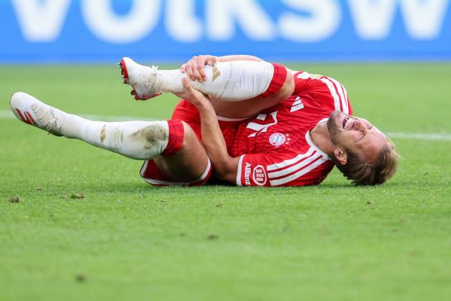 Bayern Munich's English forward #09 Harry Kane holds his jeg after sustaining an injury during the German first division Bundesliga football match between VfL Wolfsburg and FC Bayern Munich in Wolfsburg, on May 9, 2026. (Photo by Ronny HARTMANN / AFP) / DFL REGULATIONS PROHIBIT ANY USE OF PHOTOGRAPHS AS IMAGE SEQUENCES AND/OR QUASI-VIDEO