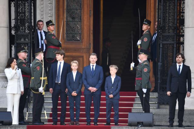 Hungary's incoming Prime Minister Peter Magyar (C) and his sons leave the parliament after his swearing-in ceremony in Budapest on May 9, 2026. Lawmakers in Hungary on May 9, 2026 swore in pro-European conservative Peter Magyar as the country's new prime minister, after elections last month that ended Viktor Orban's 16 years in power. The parliament formally elected Magyar with 140 votes for, 54 against, and one abstention in the inaugural session of the new chamber resulting from the April polls. (Photo by Ferenc ISZA / AFP)