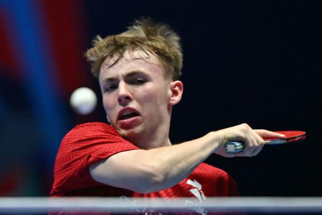 France's Flavien Coton returns to China's Wang Chuqin during their Men's Teams semi-final match at the ITTF World Table Tennis Championships in Wembley Arena, west London on May 9, 2026. (Photo by Glyn KIRK / AFP)