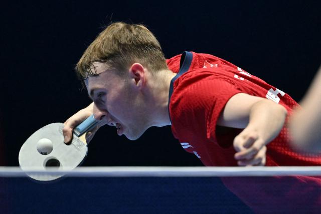 France's Flavien Coton returns to China's Wang Chuqin during their Men's Teams semi-final match at the ITTF World Table Tennis Championships in Wembley Arena, west London on May 9, 2026. (Photo by Glyn KIRK / AFP)