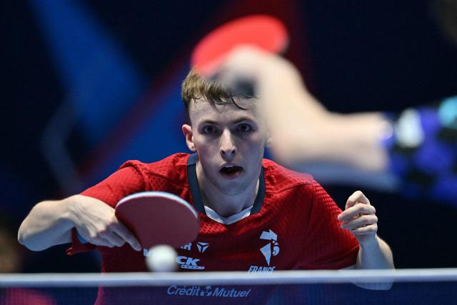 France's Flavien Coton returns to China's Wang Chuqin during their Men's Teams semi-final match at the ITTF World Table Tennis Championships in Wembley Arena, west London on May 9, 2026. (Photo by Glyn KIRK / AFP)