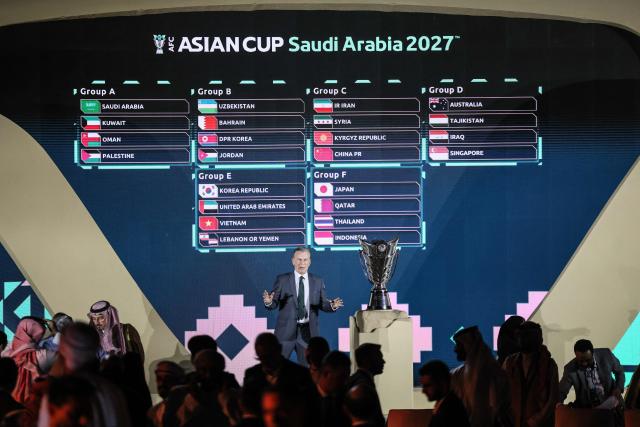 A screen displays the results of the final draw of the 2027 AFC Asian Cup during a ceremony in Diriyah, on the outskirts of Riyadh, on May 9, 2026. The 19th edition of the Asian Cup is scheduled to take place from January 7 to February 5 next year in Saudi Arabia. (Photo by Fayez NURELDINE / AFP)