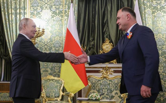 Russian President Vladimir Putin and the leader of the breakaway Georgian region of South Ossetia Alan Gagloev attend a meeting at the Kremlin in Moscow on May 9, 2026. (Photo by MAXIM SHIPENKOV / POOL / AFP)