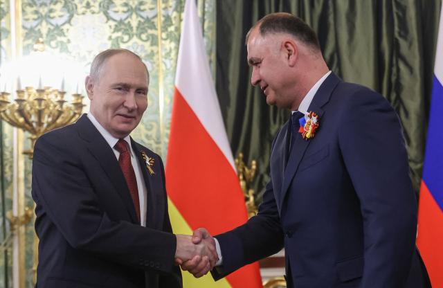 Russian President Vladimir Putin and the leader of the breakaway Georgian region of South Ossetia Alan Gagloev attend a meeting at the Kremlin in Moscow on May 9, 2026. (Photo by MAXIM SHIPENKOV / POOL / AFP)
