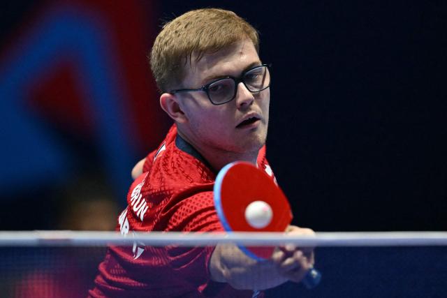 France's Alexis Lebrun returns to China's Liang Jingkun during their Men's Teams semi-final match at the ITTF World Table Tennis Championships in Wembley Arena, west London on May 9, 2026. (Photo by Glyn KIRK / AFP)