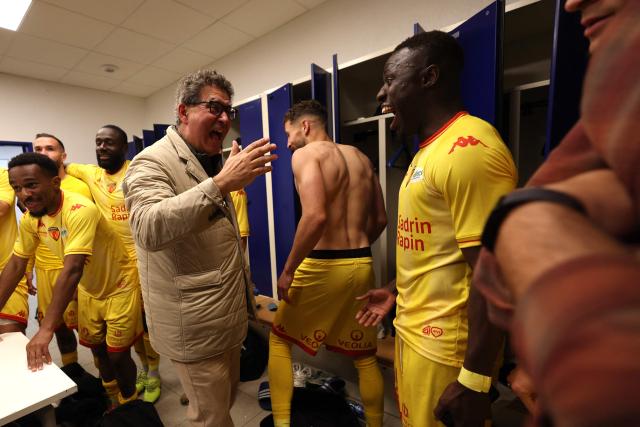 Le Mans' players and staff celebrate after winning the French L2 football match between Bastia and Le Mans at the Armand-Cesari stadium, in Bastia, on the French Mediterranean island of Corsica on May 9, 2026. Following Troyes' promotion as Ligue 2 champions, there is just one direct promotion spot left to be claimed by three clubs – Le Mans, Saint-Etienne and Red Star – on the 34th and final matchday in the evening of May 9, 2026. (Photo by Pascal POCHARD-CASABIANCA / AFP)