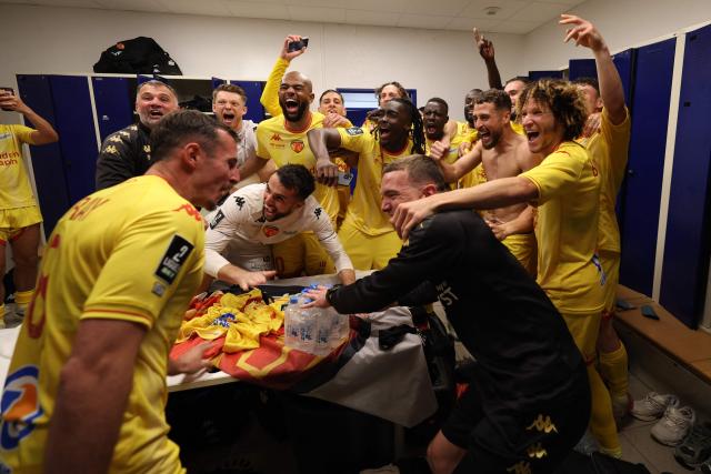 Le Mans' players and staff celebrate after winning the French L2 football match between Bastia and Le Mans at the Armand-Cesari stadium, in Bastia, on the French Mediterranean island of Corsica on May 9, 2026. Following Troyes' promotion as Ligue 2 champions, there is just one direct promotion spot left to be claimed by three clubs – Le Mans, Saint-Etienne and Red Star – on the 34th and final matchday in the evening of May 9, 2026. (Photo by Pascal POCHARD-CASABIANCA / AFP)