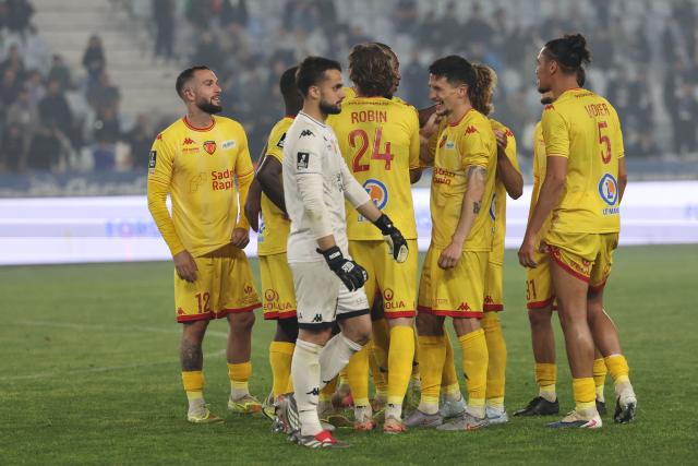 Le Mans' celebrate at the end of the French L2 football match between Bastia and Le Mans at the Armand-Cesari stadium, in Bastia, on the French Mediterranean island of Corsica on May 9, 2026. Following Troyes' promotion as Ligue 2 champions, there is just one direct promotion spot left to be claimed by three clubs – Le Mans, Saint-Etienne and Red Star – on the 34th and final matchday in the evening of May 9, 2026. (Photo by Pascal POCHARD-CASABIANCA / AFP)