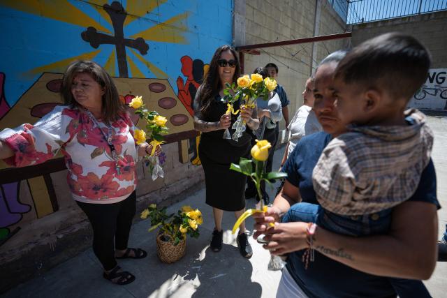 Migrant mothers receive flowers as part of mother's Day celebrations at Comunidad de Luz shelter in Tijuana, Baja California state, Mexico on May 9, 2026. (Photo by Guillermo Arias / AFP)