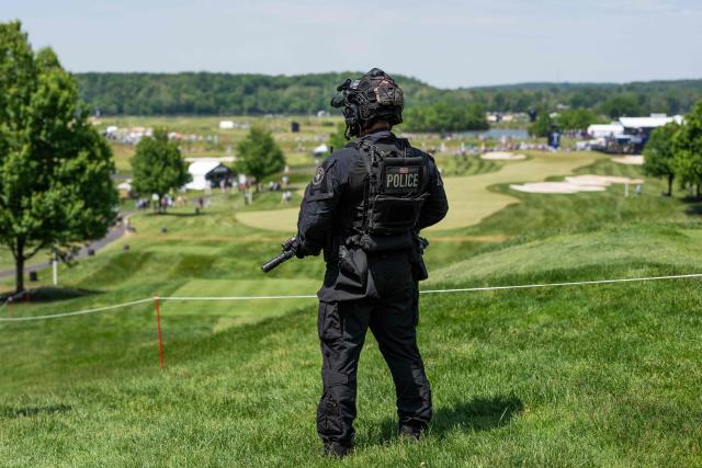 A US Secret Service Counterassault Team agent stands guard as US President Donald Trump attends the LIV Golf Virginia 2026 tournament at Trump National Golf Club in Sterling, Virginia on May 9, 2026. (Photo by Aaron Schwartz / AFP)