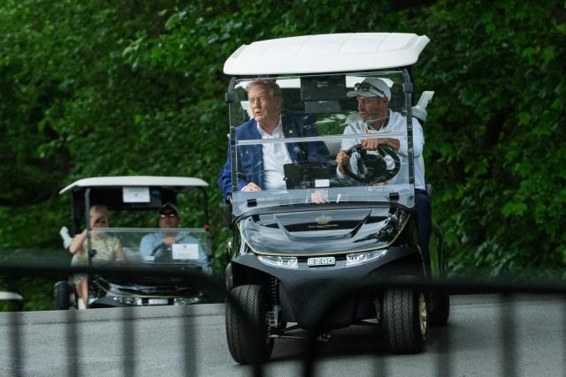 US President Donald Trump rides in a golf cart as he departs LIV Golf Virginia 2026 tournament at Trump National Golf Club in Sterling, Virginia on May 9, 2026. (Photo by Aaron Schwartz / AFP)