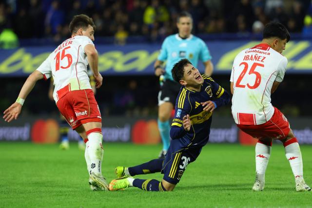 Boca Juniors' midfielder #36 Tomas Aranda reacts after being fouled between Huracan's Uruguayan midfielder #15 Facundo Waller and defender #25 Cesar Ibanez during the Argentine Professional Football League 2026 Apertura Tournament round of 16 match between Boca Juniors and Huracan at La Bombonera Stadium in Buenos Aires on May 9, 2026. (Photo by Alejandro PAGNI / AFP)