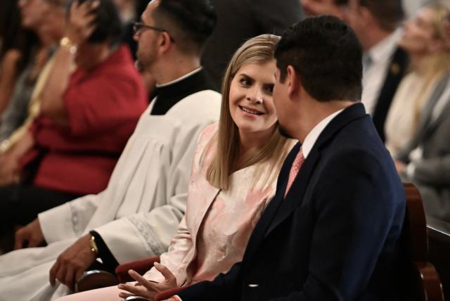 Costa Rica's President Laura Fernandez chats to her husband Jeffry Umana during a mass at Nuestra Senora de los Angeles church the day after her inauguration in San Jose on May 9, 2026. (Photo by EZEQUIEL BECERRA / AFP)