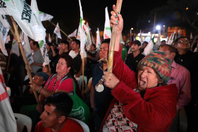 A supporter of Peru's presidential candidate Roberto Sanchez, for the Juntos por el Peru party, gestures during a rally in Huaycan community in Lima, Peru on May 9, 2026. (Photo by Connie FRANCE / AFP)