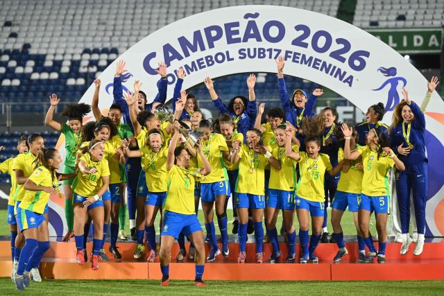 Brazil's defender #04 Andreyna lifts the trophy with her teammates after winning the Conmebol Women U-17 final football match between Brazil and Argentina at the Defensores del Chaco stadium in Asuncion on May 9, 2026. (Photo by DANIEL DUARTE / AFP)