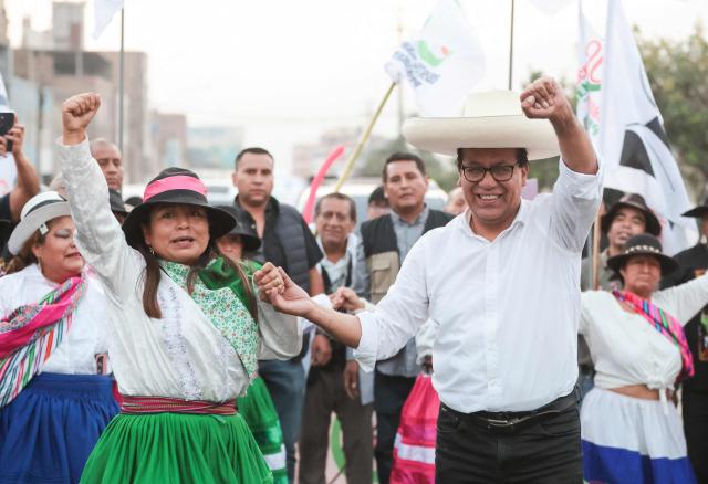 Peru's presidential candidate Roberto Sanchez, for the Juntos por el Peru party, dances with supporters during a campaign rally in Huaycan community in Lima on May 9, 2026. (Photo by Connie FRANCE / AFP)