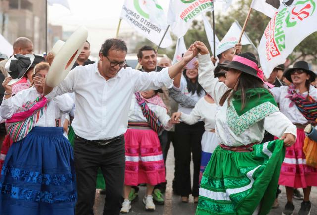 Peru's presidential candidate Roberto Sanchez, for the Juntos por el Peru party, dances with supporters during a campaign rally in Huaycan community in Lima on May 9, 2026. (Photo by Connie FRANCE / AFP)