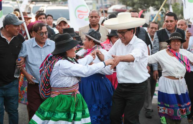 Peru's presidential candidate Roberto Sanchez, for the Juntos por el Peru party, dances with supporters during a campaign rally in Huaycan community in Lima on May 9, 2026. (Photo by Connie FRANCE / AFP)