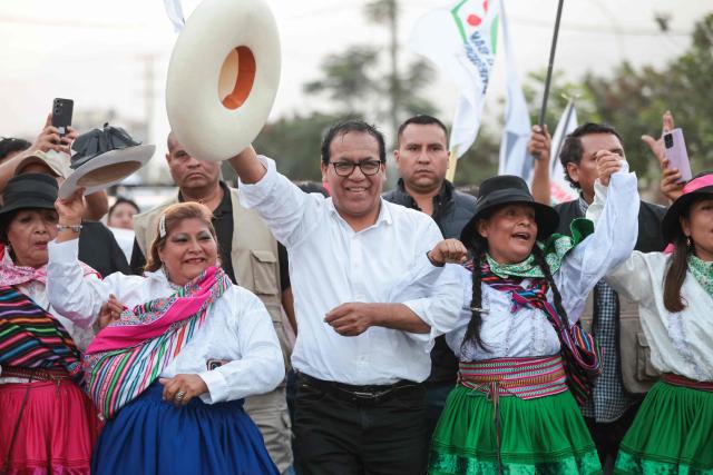 Peru's presidential candidate Roberto Sanchez, for the Juntos por el Peru party, gestures with supporters during a campaign rally in Huaycan community in Lima on May 9, 2026. (Photo by Connie FRANCE / AFP)