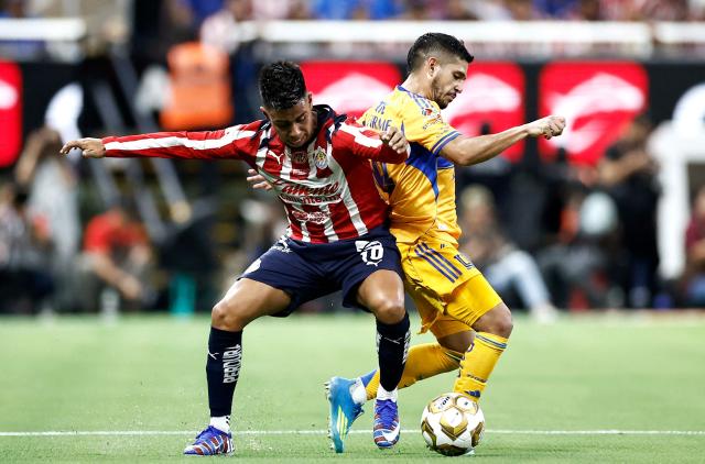 Guadalajara's forward #10 Efrain Alvarez and Tigres' midfielder #14 Jesus Garza fight for the ball during the Liga MX Clausura quarter-finals second leg football match between Guadalajara and Tigres at Akron Stadium in Guadalajara, Jalisco state, Mexico on May 9, 2026. (Photo by Ulises Ruiz / AFP)