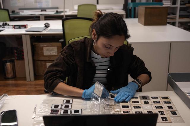 A woman restores the slide films taken by Turkish photojournalist Ara Guler at the Ara Guler Museum in Istanbul, on May 7, 2026. Frozen in time yet alive with all the glamour and spontaneity: all those moments are part of a newly opened exhibition featuring previously unseen photographs taken by Turkey's legendary photographer Ara Guler at the Cannes Film Festival between 1957 and 67. (Photo by Ozan KOSE / AFP)