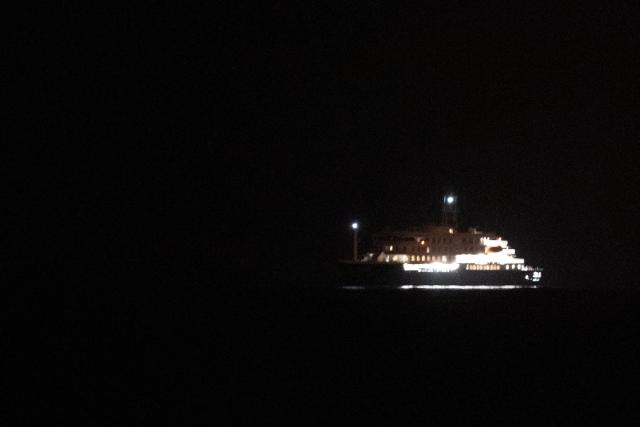The Dutch-flagged hantavirus-stricken cruise ship MV Hondius sails near El Medano, Tenerife, in the Canary Islands, Spain early on May 10, 2026. A cruise ship hit with a deadly hantavirus outbreak is headed for Spain's Canary Islands, where most of the nearly 150 people on board will be evacuated and flown home after weeks at sea. The Dutch-flagged MV Hondius is expected to reach waters off the industrial port of Granadilla de Abona in Tenerife at dawn on May 10, 2026, where WHO chief Tedros Adhanom Ghebreyesus is due to help coordinate the ship's evacuation. (Photo by Jorge GUERRERO / AFP)