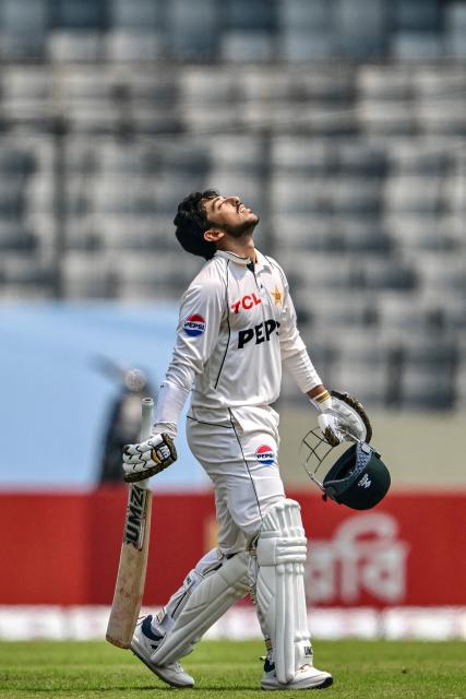 Pakistan's Azan Awais celebrates after scoring a century (100 runs) during the third day of the first Test cricket match between Bangladesh and Pakistan at the Sher-e-Bangla National Stadium in Mirpur on May 10, 2026. (Photo by Munir UZ ZAMAN / AFP)