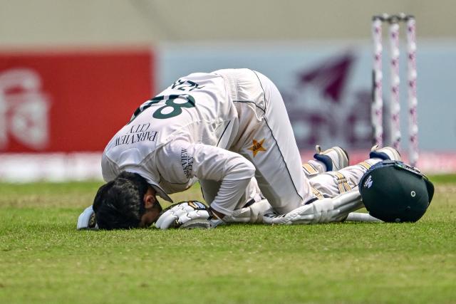 Pakistan's Azan Awais prays after scoring a century (100 runs) during the third day of the first Test cricket match between Bangladesh and Pakistan at the Sher-e-Bangla National Stadium in Mirpur on May 10, 2026. (Photo by Munir UZ ZAMAN / AFP)