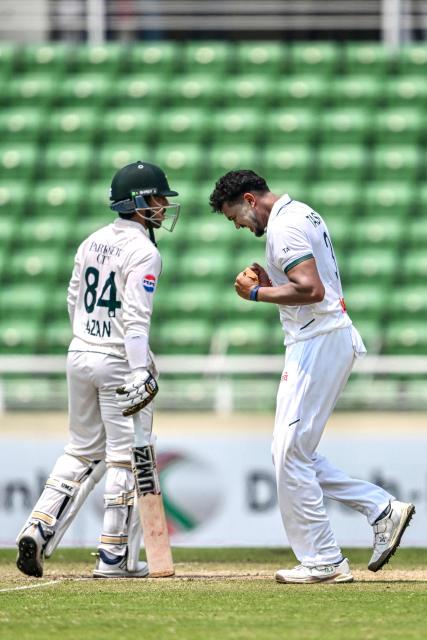 Bangladesh's Taskin Ahmed (R) celebrates after taking the wicket of Pakistan's Azan Awais (L) during the third day of the first Test cricket match between Bangladesh and Pakistan at the Sher-e-Bangla National Stadium in Mirpur on May 10, 2026. (Photo by Munir UZ ZAMAN / AFP)