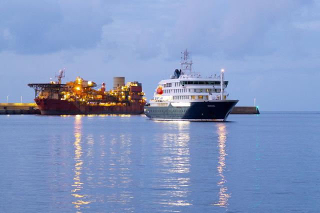 The Dutch flagged hantavirus-stricken cruise ship MV Hondius arrives to the industrial port of Granadilla de Abona on the island of Tenerife in Spain's Canary Islands to commence evacuation of passengers and most crew members on May 10, 2026. Repatriation flights for the nearly 150 passengers onboard the ship hit by a deadly hantavirus outbreak are planned to the United States, Britain, France,  and other countries, Spain's interior minister announced on Saturday. Spanish authorities have said the ship will anchor off Tenerife and will not be allowed to dock. Passengers will be transferred to shore on a smaller vessel then by bus to the airport and then flown home after weeks at sea. (Photo by JORGE GUERRERO / AFP)