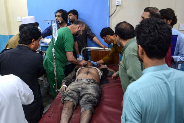 An injured victim receives treatment at a hospital following a car bombing attack by militants in Bannu on May 10, 2026. Militants detonated a car bomb at a checkpoint in northwestern Pakistan and opened fire on police, killing at least 12 and wounding five, officials said on May 10. (Photo by Karim ULLAH / AFP)