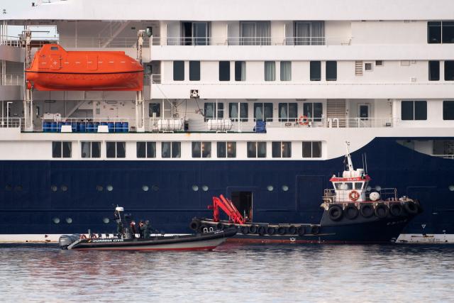Boats used for evacuation operations approach the Dutch flagged hantavirus-stricken cruise ship MV Hondius at the industrial port of Granadilla de Abona on the island of Tenerife in Spain's Canary Islands on May 10, 2026. Repatriation flights for the nearly 150 passengers onboard the ship hit by a deadly hantavirus outbreak are planned to the United States, Britain, France,  and other countries, Spain's interior minister announced on Saturday. Most of the nearly 150 people on board will be transferred to shore on smaller vessels then by bus to the airport and then flown home after weeks at sea. (Photo by JORGE GUERRERO / AFP)