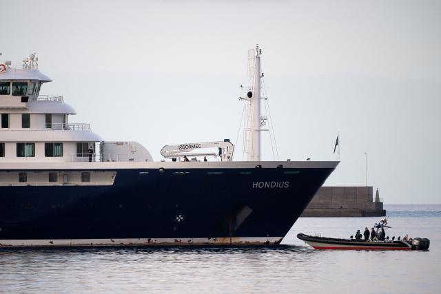 A civil guard boat patrols before evacuation operations on the Dutch flagged hantavirus-stricken cruise ship MV Hondius at the industrial port of Granadilla de Abona on the island of Tenerife in Spain's Canary Islands on May 10, 2026. Repatriation flights for the nearly 150 passengers onboard the ship hit by a deadly hantavirus outbreak are planned to the United States, Britain, France,  and other countries, Spain's interior minister announced on Saturday. Most of the nearly 150 people on board will be transferred to shore on smaller vessels then by bus to the airport and then flown home after weeks at sea. (Photo by JORGE GUERRERO / AFP)