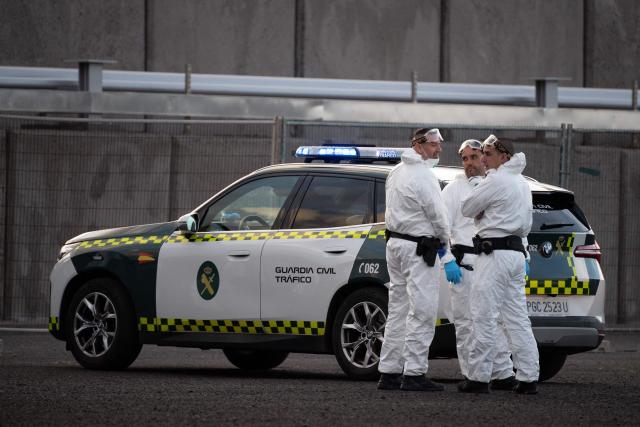 Spanish civil guard members wear protective suits as the Dutch flagged hantavirus-stricken cruise ship MV Hondius arrived at the industrial port of Granadilla de Abona on the island of Tenerife in Spain's Canary Islands on May 10, 2026. Repatriation flights for the nearly 150 passengers onboard the ship hit by a deadly hantavirus outbreak are planned to the United States, Britain, France,  and other countries, Spain's interior minister announced on Saturday. Most of the nearly 150 people on board will be transferred to shore on smaller vessels then by bus to the airport and then flown home after weeks at sea. (Photo by JORGE GUERRERO / AFP)
