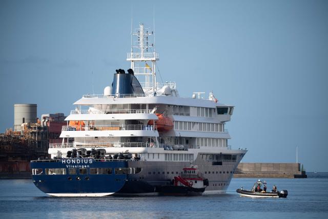 Boats approach the Dutch flagged hantavirus-stricken cruise ship MV Hondius after it arrived at the industrial port of Granadilla de Abona on the island of Tenerife in Spain's Canary Islands on May 10, 2026. Repatriation flights for the nearly 150 passengers onboard the ship hit by a deadly hantavirus outbreak are planned to the United States, Britain, France,  and other countries, Spain's interior minister announced on Saturday. Most of the nearly 150 people on board will be transferred to shore on smaller vessels then by bus to the airport and then flown home after weeks at sea. (Photo by JORGE GUERRERO / AFP)