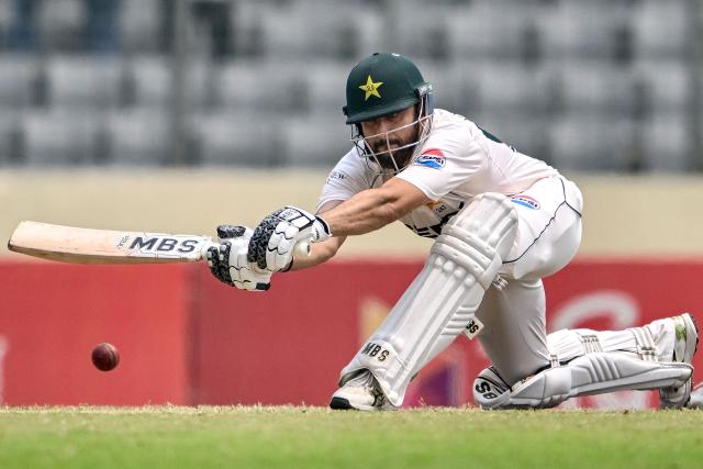 Pakistan's Salman Agha plays a shot during the third day of the first Test cricket match between Bangladesh and Pakistan at the Sher-e-Bangla National Stadium in Mirpur on May 10, 2026. (Photo by Munir UZ ZAMAN / AFP)
