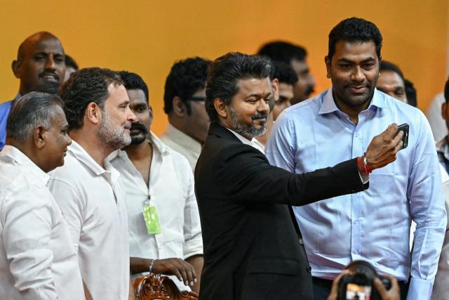 Newly elected chief minister of India's Tamil Nadu state, C. Joseph Vijay (2R) takes a selfie with Indian National Congress (INC) party leader Rahul Gandhi (2L) and others during his swearing-in ceremony in Chennai on May 10, 2026. (Photo by R.Satish BABU / AFP)