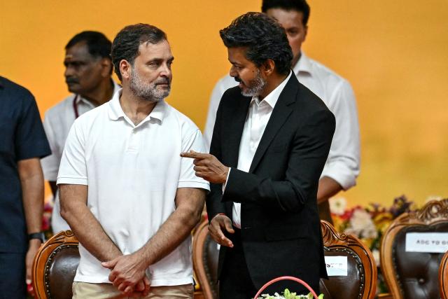 Newly elected chief minister of India's Tamil Nadu state, C. Joseph Vijay (R) speaks with Indian National Congress (INC) party leader Rahul Gandhi after taking the oath during his swearing-in ceremony in Chennai on May 10, 2026. (Photo by R.Satish BABU / AFP)