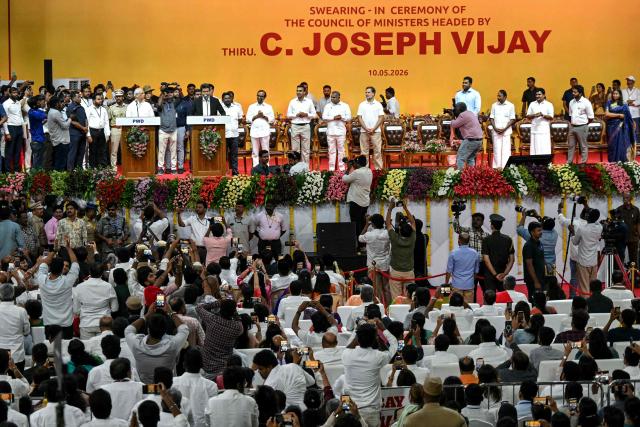 Newly elected chief minister of India's Tamil Nadu state, C. Joseph Vijay (center, 5L) takes an oath during his swearing-in ceremony in Chennai on May 10, 2026. Indian film superstar C. Joseph Vijay was on May 10 sworn in as chief minister of Tamil Nadu state, after his party emerged as the single largest following elections in the industrial hub. (Photo by R.Satish BABU / AFP)