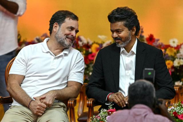 Newly elected chief minister of India's Tamil Nadu state, C. Joseph Vijay (R) speaks with Indian National Congress (INC) party leader Rahul Gandhi before taking the oath during his swearing-in ceremony in Chennai on May 10, 2026. (Photo by R.Satish BABU / AFP)