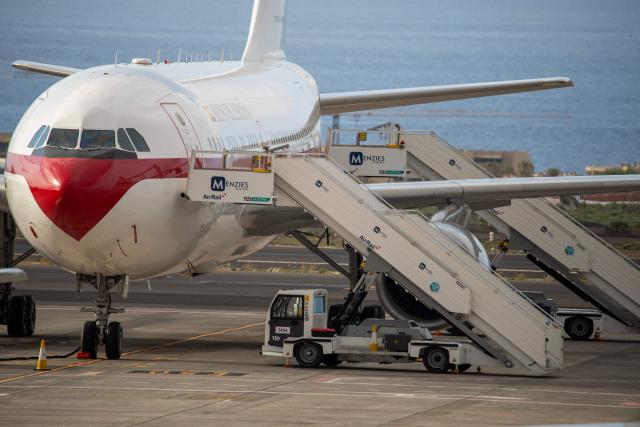 A Spanish air force plane stands idle at the Tenerife Sur-Reina Sofia airport awaiting Spanish evacuees from the Dutch flagged hantavirus-stricken cruise ship MV Hondius which arrived at the industrial port of Granadilla de Abona on the island of Tenerife in Spain's Canary Islands on May 10, 2026. Repatriation flights for the nearly 150 passengers onboard the ship hit by a deadly hantavirus outbreak are planned to the United States, Britain, France,  and other countries, Spain's interior minister announced on Saturday. Most of the nearly 150 people on board will be transferred to shore on smaller vessels then by bus to the airport and then flown home after weeks at sea. (Photo by Antonio Sempere / AFP)