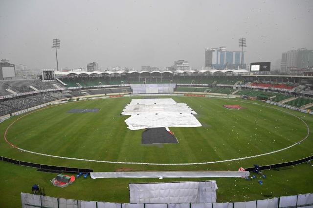 A general view shows the covered pitch as rain stops the play during the third day of the first Test cricket match between Bangladesh and Pakistan at the Sher-e-Bangla National Stadium in Mirpur on May 10, 2026. (Photo by Munir UZ ZAMAN / AFP)