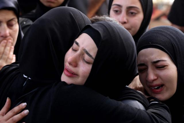 Family members grieve the day after nine people were killed in an Israeli airstrike on the southern Lebanese village of Jibshit, during their funeral in the city of Sidon on May 10, 2026. Israel carried out strikes across Lebanon on May 9, 2026, killing at least nine people in the south according to authorities, with raids also targeting a highway not far from Beirut outside of Hezbollah's traditional strongholds. Lebanon was drawn into the Middle East war on March 2 when Tehran-backed militant group Hezbollah launched attacks on Israel to avenge the killing of the Iranian leader. Israel has responded with broad strikes across Lebanon and a ground offencive. (Photo by MAHMOUD ZAYYAT / AFP)