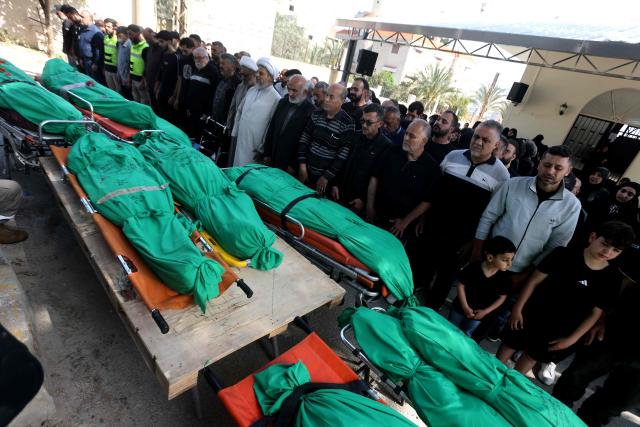 Relatives and friends pray over the bodies of nine people killed the day before in an Israeli airstrike on the southern Lebanese village of Jibshit, during their funeral in the city of Sidon on May 10, 2026. Israel carried out strikes across Lebanon on May 9, 2026, killing at least nine people in the south according to authorities, with raids also targeting a highway not far from Beirut outside of Hezbollah's traditional strongholds. Lebanon was drawn into the Middle East war on March 2 when Tehran-backed militant group Hezbollah launched attacks on Israel to avenge the killing of the Iranian leader. Israel has responded with broad strikes across Lebanon and a ground offencive. (Photo by MAHMOUD ZAYYAT / AFP)